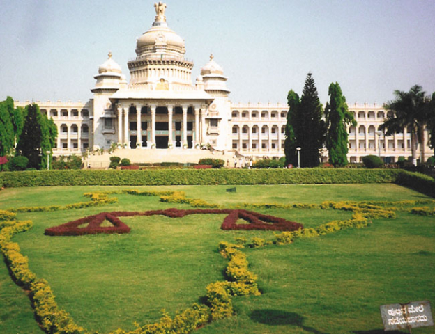 Bangalore. It is called "Vidhana Soudha". You could call it as Karnata Parliament Building.   The sign in the bottom right reads "Do not walk on grass"